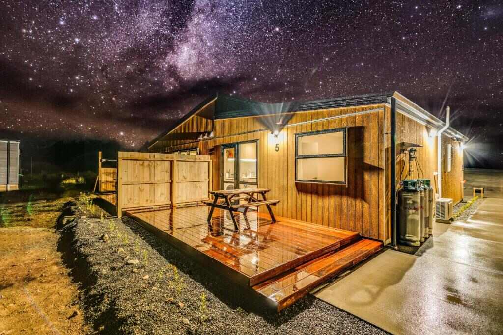 Sunshine Suites lit at night beneath the Milky Way in Lake Tekapo