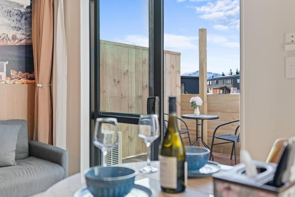 View from a Sunshine Suites living area towards the private deck and mountains