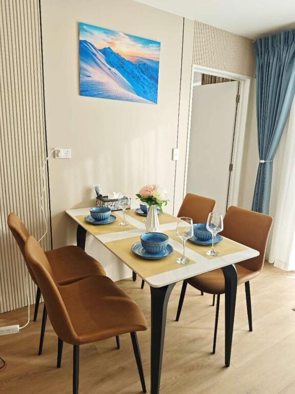 Dining table set for four inside a Sunshine Suites apartment